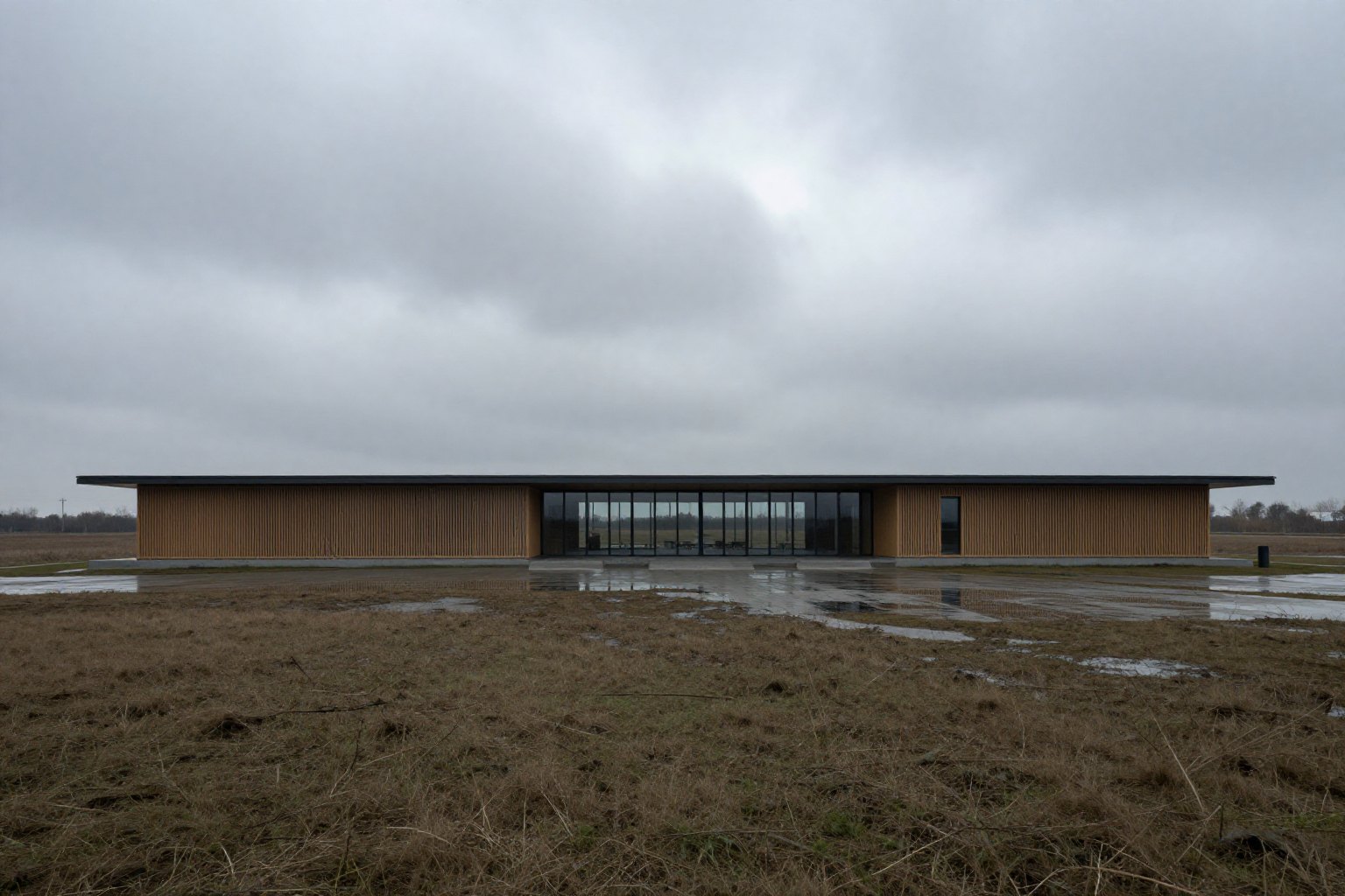 Architect-designed house sitting in a wide landscape at dusk