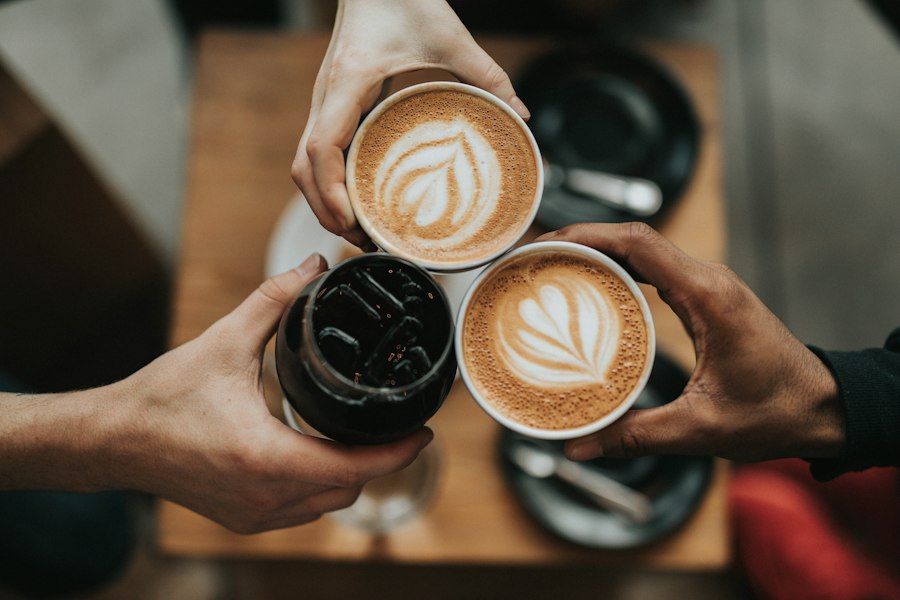 Hands holding a coffee cup outdoors